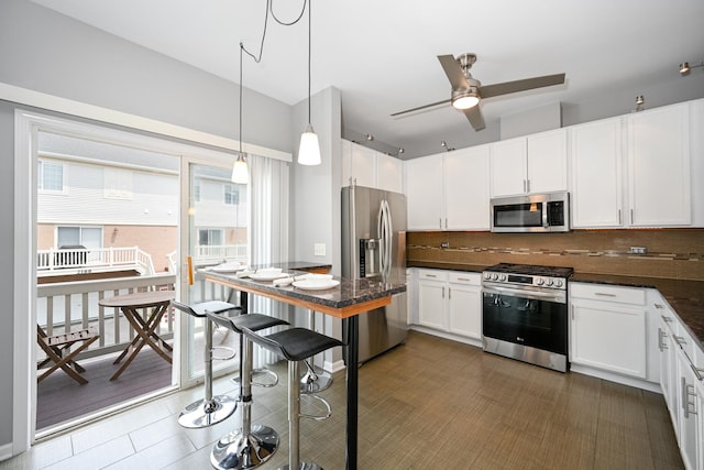 2208 W Concord Ln, Addison, IL 60101 - kitchen featuring stainless steel appliances, dark countertops, backsplash, and white cabinets