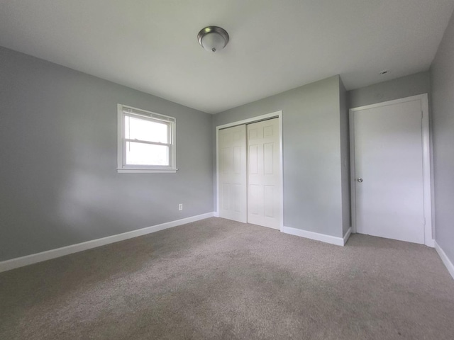 1718 Gilboa Ave, Zion, IL 60099 - unfurnished bedroom with a closet and carpet