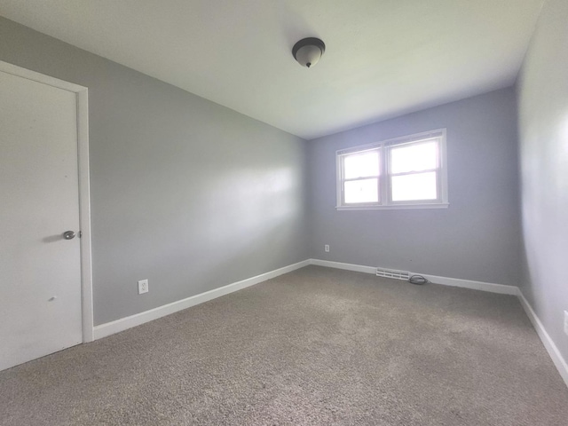 1718 Gilboa Ave, Zion, IL 60099 - unfurnished room with dark carpet
