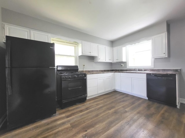 1718 Gilboa Ave, Zion, IL 60099 - kitchen with black appliances, white cabinetry, and dark wood-style floors