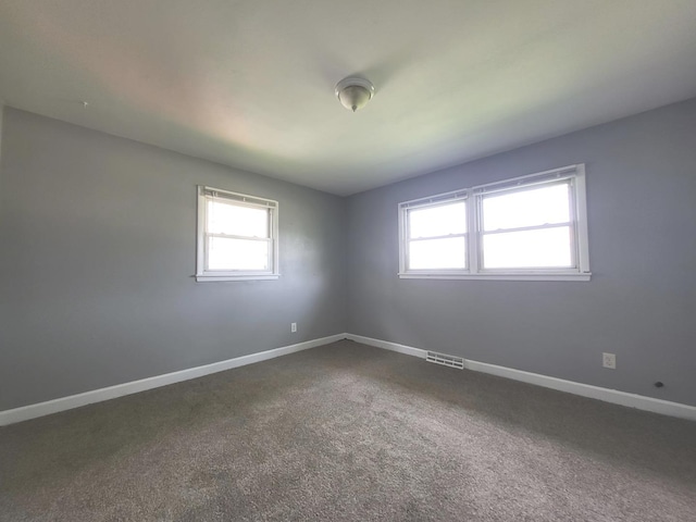 1718 Gilboa Ave, Zion, IL 60099 - unfurnished room with baseboards and dark colored carpet