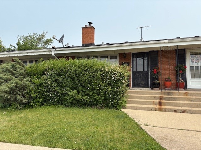 8801 Robin Dr Unit C, Des Plaines, IL 60016 - ranch-style house featuring a chimney, a front lawn, and brick siding