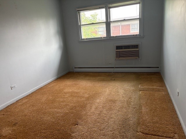 8801 Robin Dr Unit C, Des Plaines, IL 60016 - carpeted spare room featuring baseboard heating and a wall unit AC
