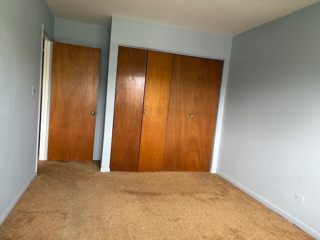 8801 Robin Dr Unit C, Des Plaines, IL 60016 - unfurnished bedroom featuring carpet flooring and a closet
