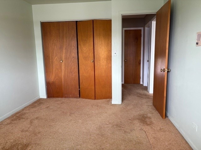 8801 Robin Dr Unit C, Des Plaines, IL 60016 - unfurnished bedroom featuring light carpet and a closet