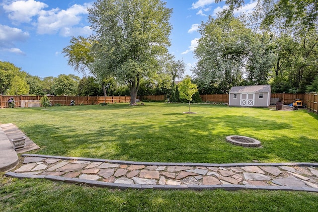 1910 Heather Ln, Joliet, IL 60431 - fenced backyard with a fire pit, a storage shed, and view of scattered trees