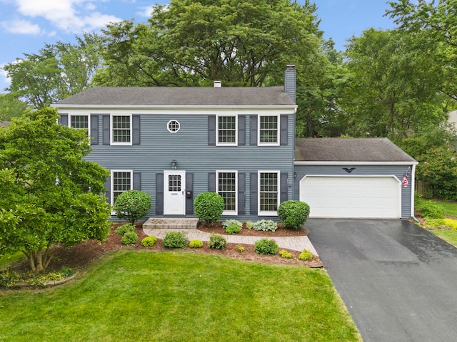 116 W Bailey Rd, Naperville, IL 60565 - colonial home featuring a chimney, a garage, driveway, a front lawn, and a shingled roof
