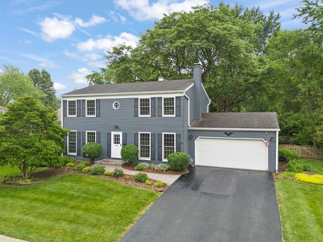 116 W Bailey Rd, Naperville, IL 60565 - colonial home with an attached garage, a chimney, asphalt driveway, and a shingled roof
