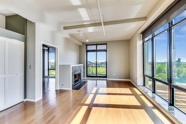 1525 S Sangamon St Unit 609, Chicago, IL 60608 - unfurnished living room featuring plenty of natural light, wood finished floors, and a fireplace