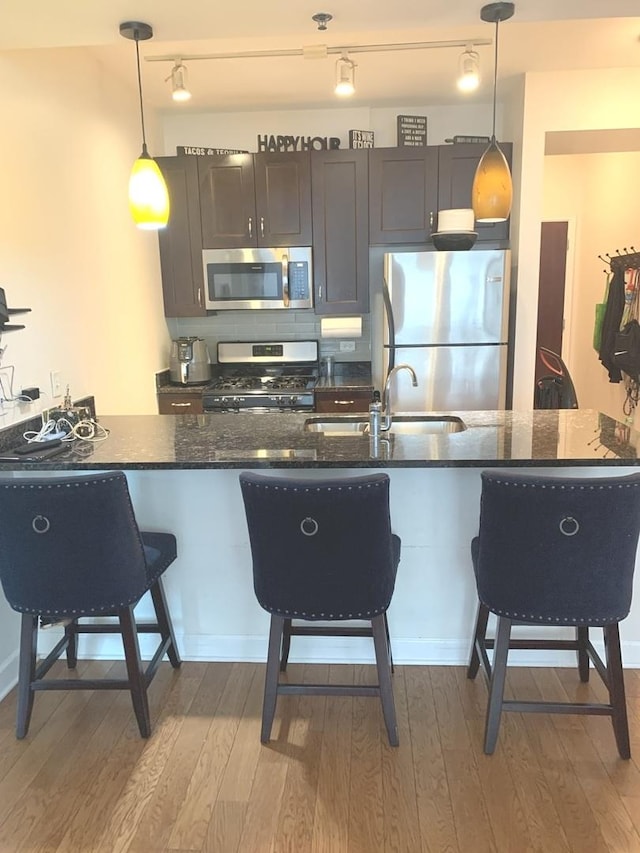 1400 S Michigan Ave Unit 911, Chicago, IL 60605 - kitchen with stainless steel appliances, a breakfast bar area, wood finished floors, and pendant lighting