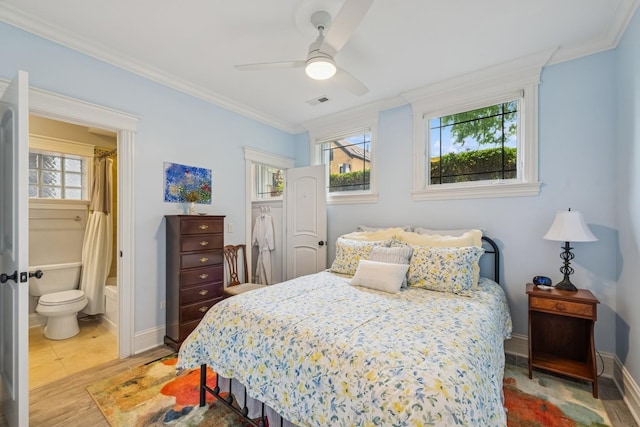 1430 W Diversey Pkwy Unit 1, Chicago, IL 60614 - bedroom with crown molding, light wood-style flooring, ensuite bathroom, and ceiling fan