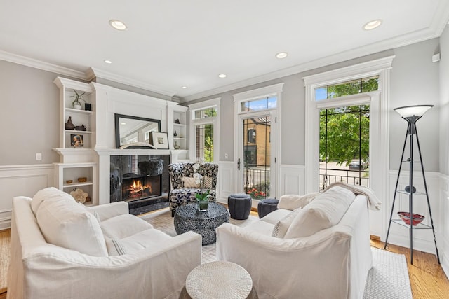 1430 W Diversey Pkwy Unit 1, Chicago, IL 60614 - living area featuring crown molding, wainscoting, light wood-style flooring, a premium fireplace, and recessed lighting