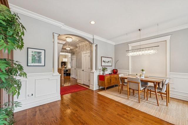 1430 W Diversey Pkwy Unit 1, Chicago, IL 60614 - dining area with decorative columns, arched walkways, wood finished floors, a decorative wall, and crown molding