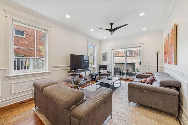 1430 W Diversey Pkwy Unit 1, Chicago, IL 60614 - living area with a decorative wall, crown molding, wainscoting, wood finished floors, and a ceiling fan