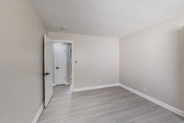 8433 W Betty Ter W, Niles, IL 60714 - empty room with light wood finished floors and a smoke detector