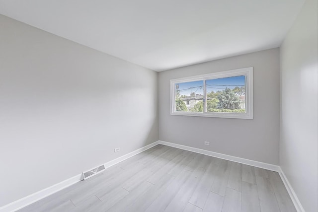 8433 W Betty Ter W, Niles, IL 60714 - empty room with light wood finished floors and baseboards