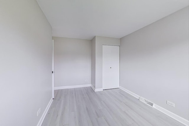 8433 W Betty Ter W, Niles, IL 60714 - empty room with light wood-type flooring and baseboards