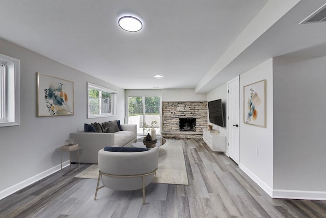 8433 W Betty Ter W, Niles, IL 60714 - living room featuring wood finished floors and a stone fireplace