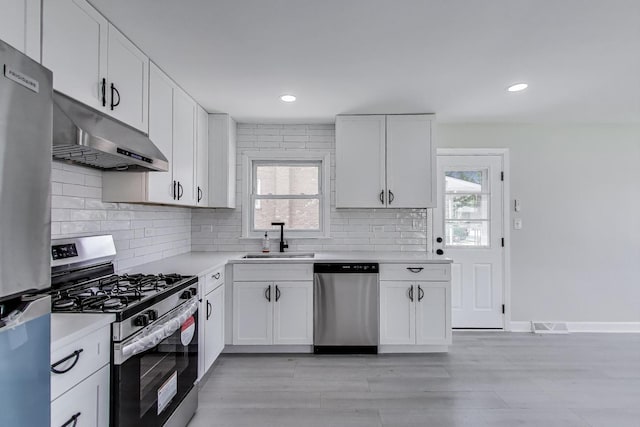 8433 W Betty Ter W, Niles, IL 60714 - kitchen with stainless steel appliances, under cabinet range hood, plenty of natural light, light countertops, and recessed lighting