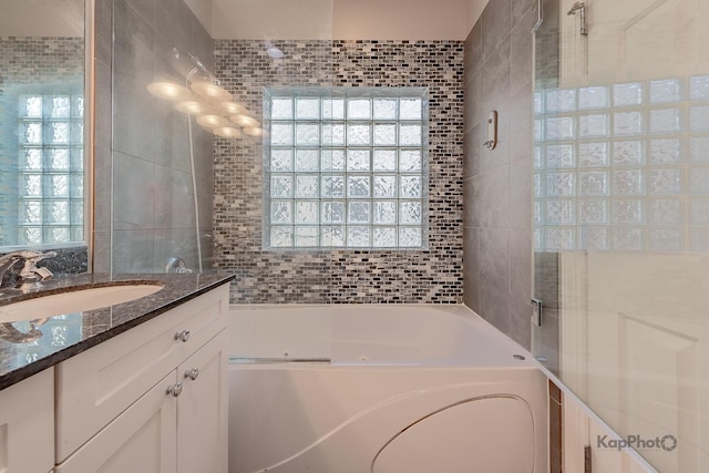 3454 N Ashland Ave Unit 4S, Chicago, IL 60657 - bathroom featuring a jetted tub, vanity, and tile walls