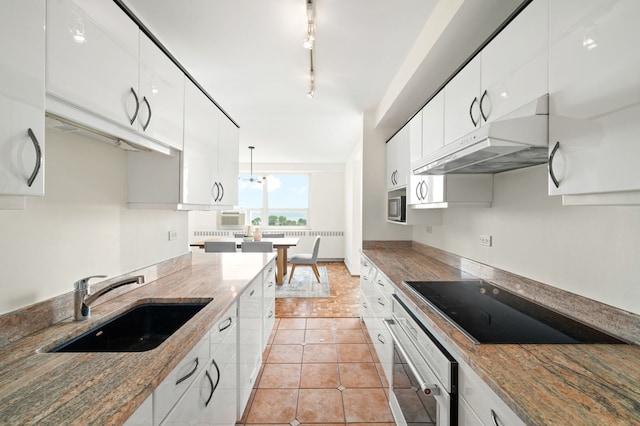 3180 N Lake Shore Dr Unit 8A, Chicago, IL 60657 - kitchen featuring oven, black electric cooktop, under cabinet range hood, white cabinets, and stainless steel microwave