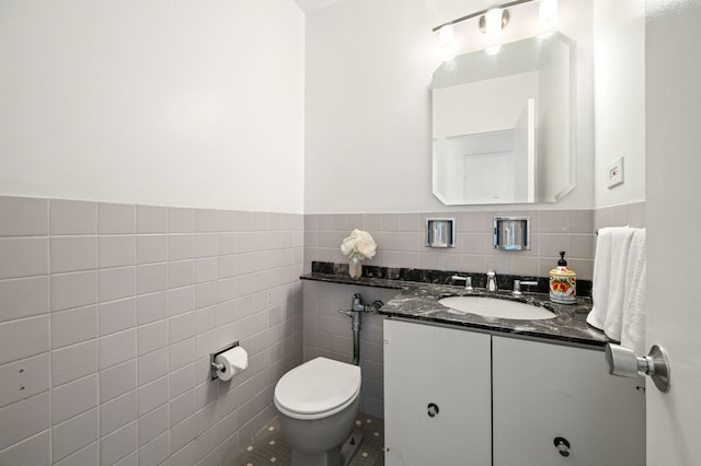 3180 N Lake Shore Dr Unit 8A, Chicago, IL 60657 - half bathroom featuring tile walls, vanity, and wainscoting