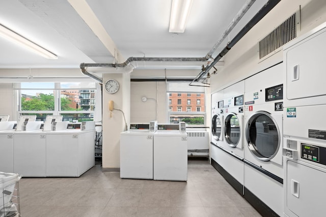 3180 N Lake Shore Dr Unit 8A, Chicago, IL 60657 - shared laundry with stacked washing machine and dryer, washer and clothes dryer, and plenty of natural light
