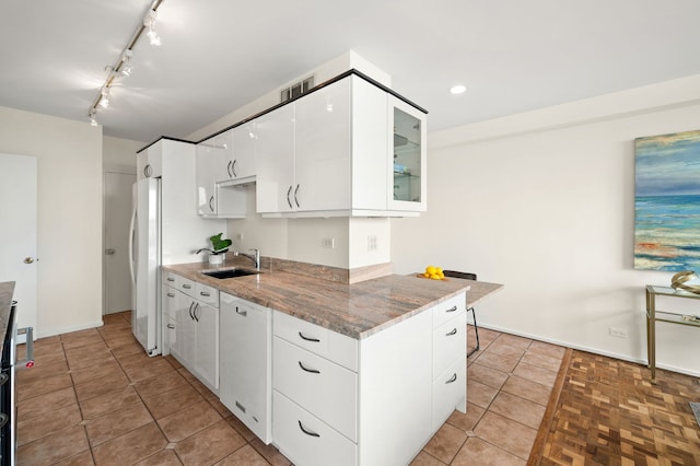 3180 N Lake Shore Dr Unit 8A, Chicago, IL 60657 - kitchen with white appliances, white cabinets, stone counters, glass insert cabinets, and rail lighting