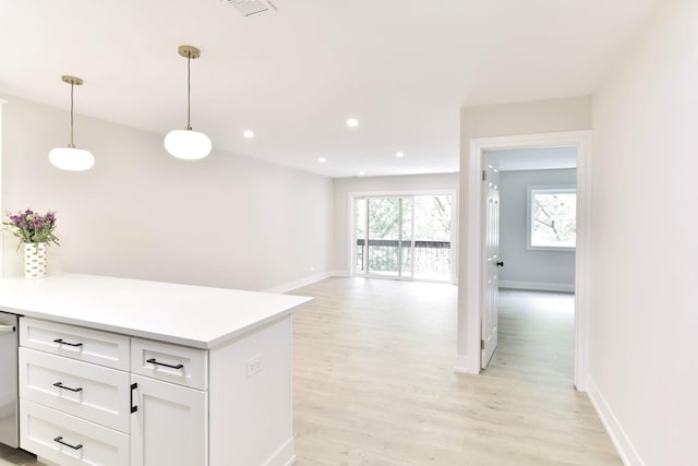 1400 N Elmhurst Rd Unit 310, Mount Prospect, IL 60056 - kitchen featuring light wood-style flooring, white cabinetry, light countertops, hanging light fixtures, and a peninsula