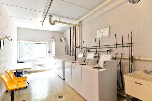 1400 N Elmhurst Rd Unit 310, Mount Prospect, IL 60056 - shared laundry featuring washing machine and dryer, light flooring, concrete block wall, and a baseboard heating unit