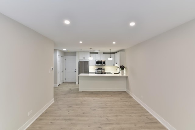 1400 N Elmhurst Rd Unit 310, Mount Prospect, IL 60056 - kitchen with appliances with stainless steel finishes, recessed lighting, light wood-type flooring, light countertops, and white cabinetry