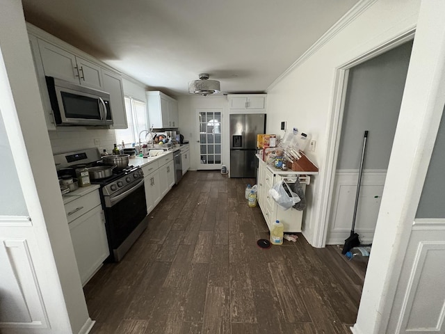409 W 15th St, Chicago Heights, IL 60411 - kitchen with stainless steel appliances, dark wood-type flooring, light countertops, white cabinets, and tasteful backsplash