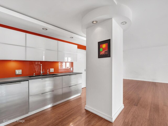 211 E Ohio St Unit 2707, Chicago, IL 60611 - kitchen with modern cabinets, wood finished floors, white cabinets, dishwasher, and dark countertops