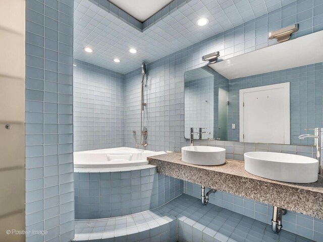 211 E Ohio St Unit 2707, Chicago, IL 60611 - full bathroom with tiled tub, tile walls, recessed lighting, and decorative backsplash