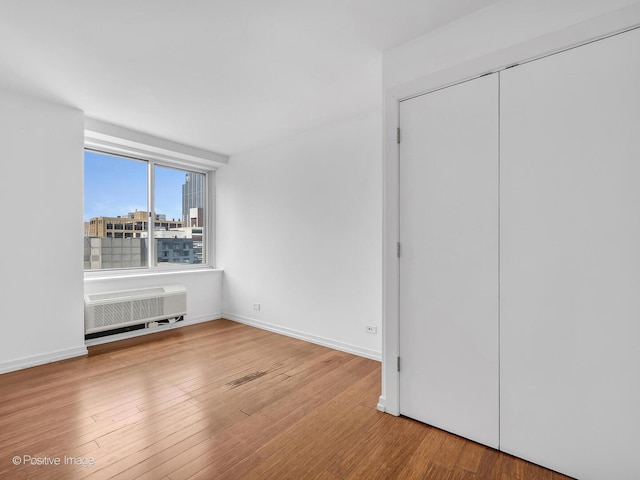 211 E Ohio St Unit 2707, Chicago, IL 60611 - unfurnished bedroom with wood finished floors and a closet
