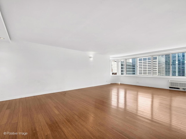 211 E Ohio St Unit 2707, Chicago, IL 60611 - unfurnished room with hardwood / wood-style floors and an AC wall unit