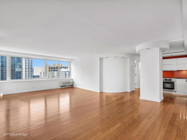 211 E Ohio St Unit 2707, Chicago, IL 60611 - unfurnished living room featuring wood finished floors and baseboards