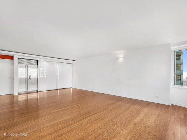 211 E Ohio St Unit 2707, Chicago, IL 60611 - empty room with light wood-style floors and baseboards