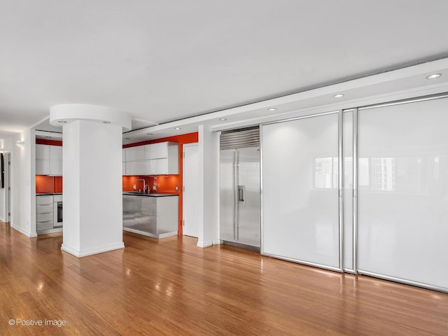 211 E Ohio St Unit 2707, Chicago, IL 60611 - unfurnished living room with light wood-style floors, bar area, and recessed lighting