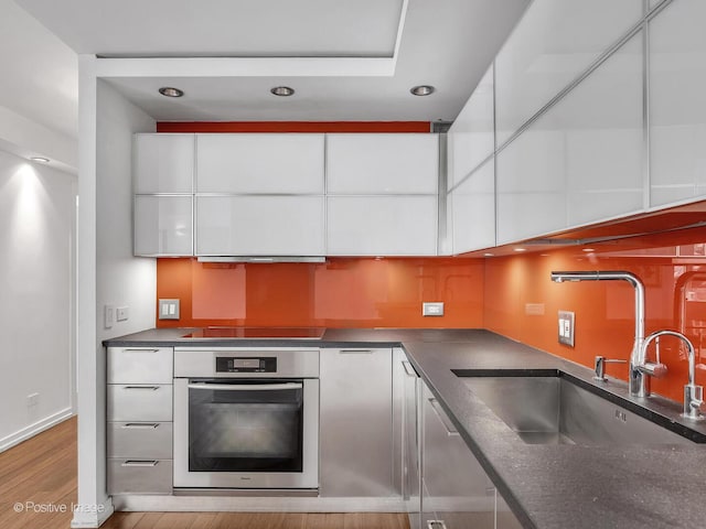 211 E Ohio St Unit 2707, Chicago, IL 60611 - kitchen with stainless steel oven, modern cabinets, white cabinetry, and recessed lighting