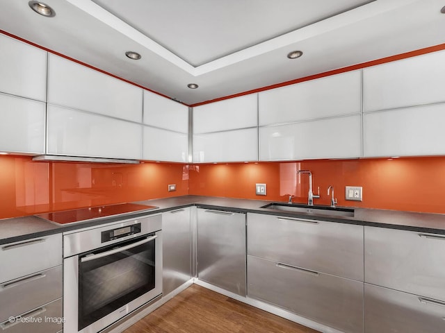 211 E Ohio St Unit 2707, Chicago, IL 60611 - kitchen with oven, recessed lighting, white cabinets, wood finished floors, and modern cabinets