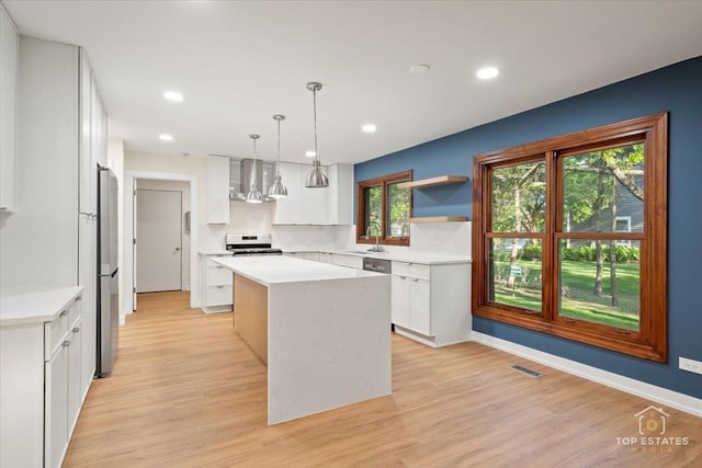 21824 Cambridge Dr, Kildeer, IL 60047 - kitchen featuring stove, a kitchen island, exhaust hood, light wood-style floors, and recessed lighting