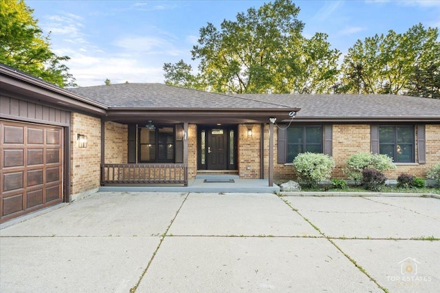 21824 Cambridge Dr, Kildeer, IL 60047 - ranch-style house with brick siding, covered porch, a shingled roof, and a garage