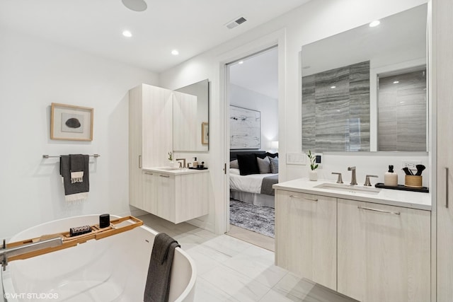 128 S Green St Unit 5Ab, Chicago, IL 60607 - ensuite bathroom with two vanities, a freestanding bath, recessed lighting, and marble finish floors