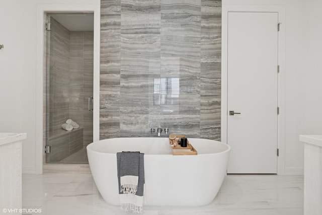 128 S Green St Unit 5Ab, Chicago, IL 60607 - full bath featuring marble finish flooring, a freestanding tub, and a shower stall