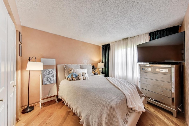 738 Hapsfield Ln Unit 7A2, Buffalo Grove, IL 60089 - bedroom featuring a textured ceiling and wood finished floors