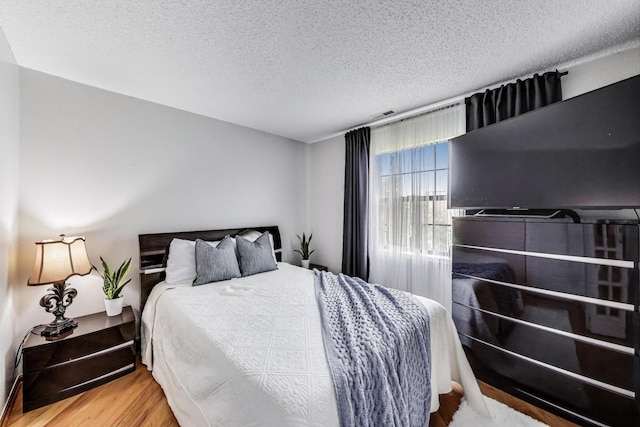 738 Hapsfield Ln Unit 7A2, Buffalo Grove, IL 60089 - bedroom with a textured ceiling and wood finished floors