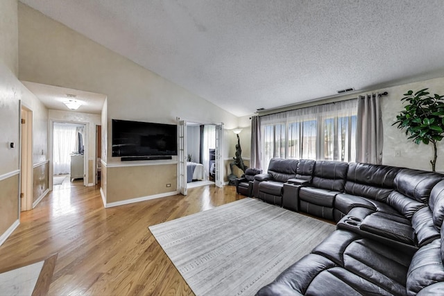 738 Hapsfield Ln Unit 7A2, Buffalo Grove, IL 60089 - living area featuring light wood-type flooring, a textured ceiling, and vaulted ceiling