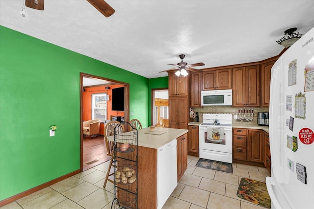 9101 US Highway 36, Metcalf, IL 61940 - kitchen featuring white appliances, a ceiling fan, a kitchen breakfast bar, and light countertops