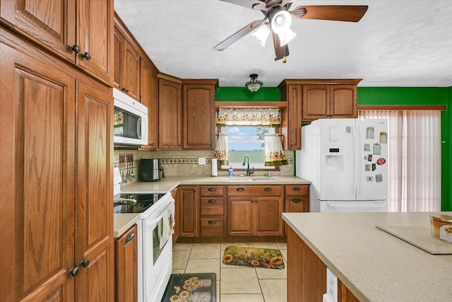 9101 US Highway 36, Metcalf, IL 61940 - kitchen with white appliances, light countertops, decorative backsplash, brown cabinets, and a ceiling fan